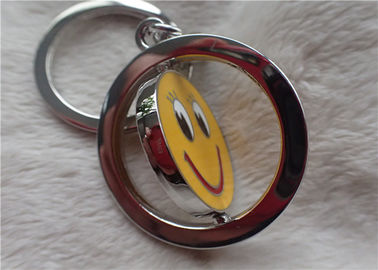 Colori i regali promozionali personali d'argento della catena chiave con il fronte giallo sorridente rotabile