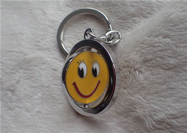 Colori i regali promozionali personali d'argento della catena chiave con il fronte giallo sorridente rotabile
