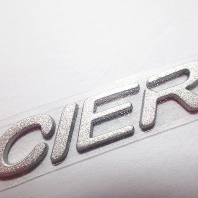 Le etichette su misura dell'abbigliamento del trasferimento di calore del silicone 3D con argento Shinny il colore