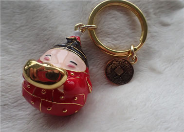 Catena chiave del bambino di stile cinese del lingotto grasso ceramico dell'oro in cappotto rosso